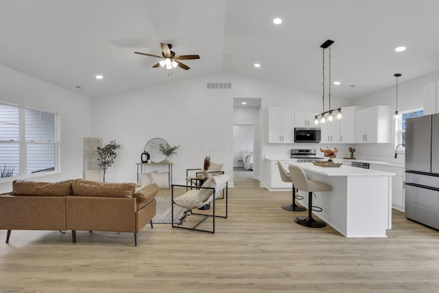 13081 Dogwood Rd NE, Thornville, OH 43076 - living area with ceiling fan, light wood-type flooring, vaulted ceiling, and recessed lighting