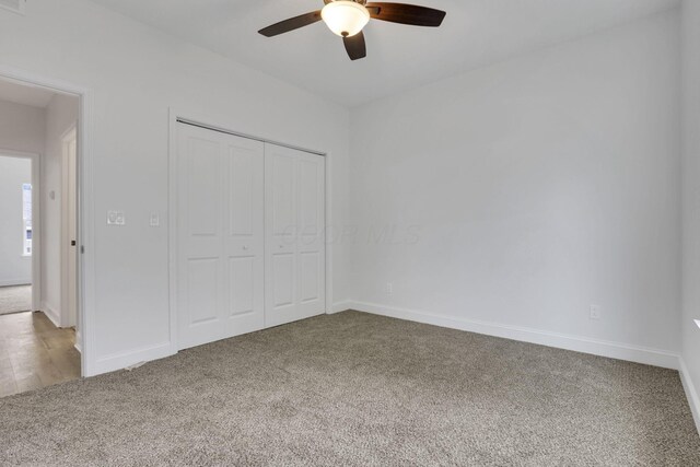 13081 Dogwood Rd NE, Thornville, OH 43076 - unfurnished bedroom with carpet, a closet, baseboards, and a ceiling fan