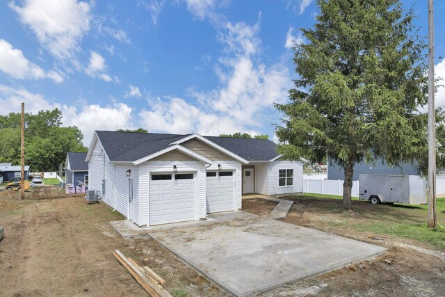 13081 Dogwood Rd NE, Thornville, OH 43076 - view of front of home with a garage, driveway, roof with shingles, and cooling unit