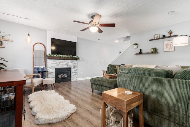 7765 Lantana Ave Unit 164, Blacklick, OH 43004 - living area with ceiling fan, wood finished floors, a textured ceiling, and a glass covered fireplace