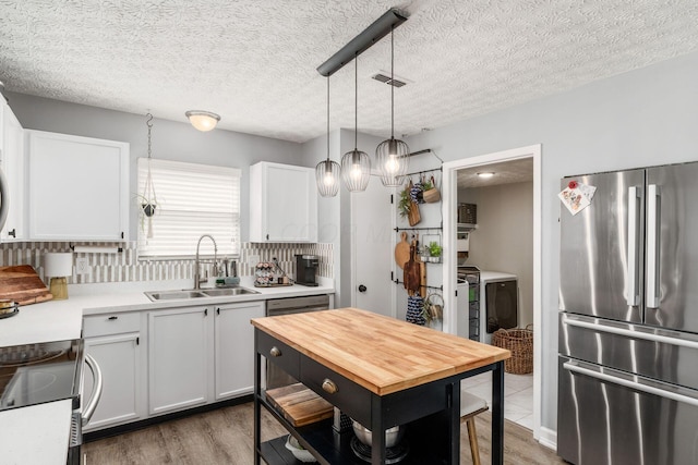 7765 Lantana Ave Unit 164, Blacklick, OH 43004 - kitchen featuring freestanding refrigerator, a sink, electric range oven, white cabinetry, and butcher block counters