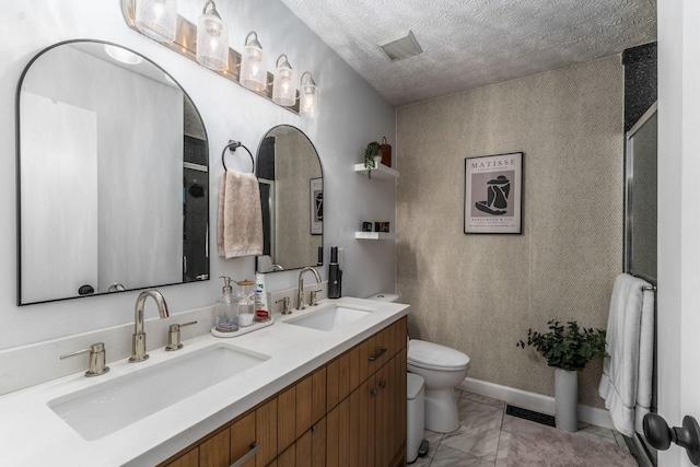 7765 Lantana Ave Unit 164, Blacklick, OH 43004 - bathroom with toilet, double vanity, marble look tiles, a textured ceiling, and a shower