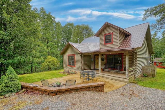 7 Whiskey Run Rd, Chillicothe, OH 45601 - view of front facade featuring metal roof, a front lawn, log siding, and a patio