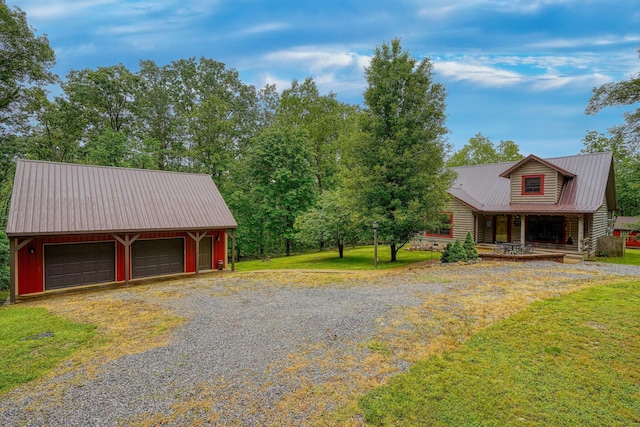 7 Whiskey Run Rd, Chillicothe, OH 45601 - view of home's exterior featuring metal roof, a garage, a porch, an outdoor structure, and a lawn
