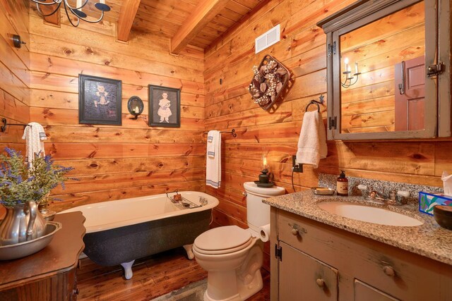 7 Whiskey Run Rd, Chillicothe, OH 45601 - bathroom with wooden ceiling with exposed beams, a soaking tub, vanity, wood walls, and toilet