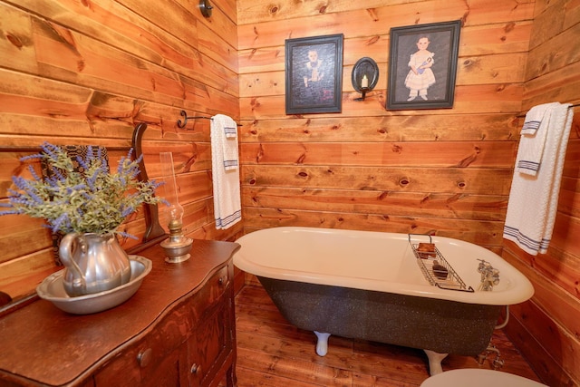 7 Whiskey Run Rd, Chillicothe, OH 45601 - bathroom featuring wood walls, a freestanding bath, and wood finished floors