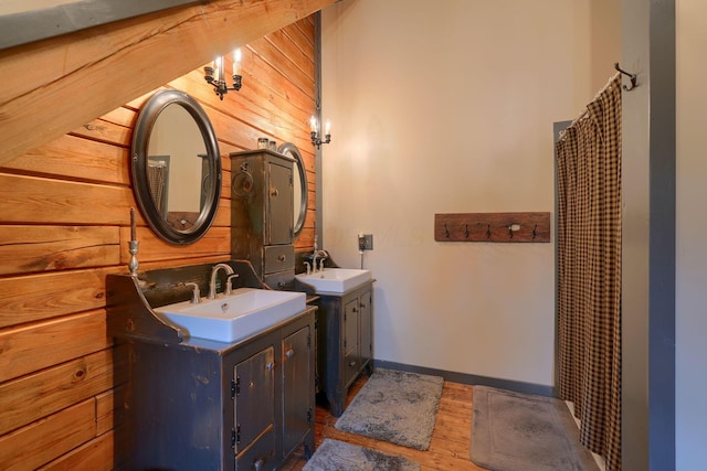 7 Whiskey Run Rd, Chillicothe, OH 45601 - bathroom featuring wood walls, wood finished floors, two vanities, a shower with shower curtain, and baseboards