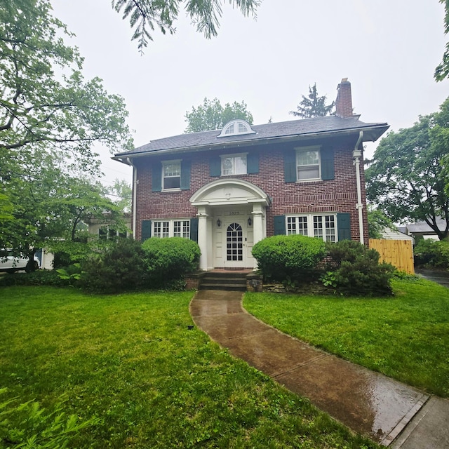 1875 King Ave, Columbus, OH 43212 - georgian-style home featuring a chimney, brick siding, and a front yard