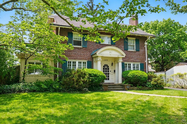 1875 King Ave, Columbus, OH 43212 - colonial house featuring brick siding, a front yard, and a chimney