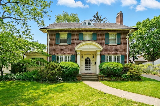 1875 King Ave, Columbus, OH 43212 - colonial inspired home with a chimney, a front yard, and brick siding