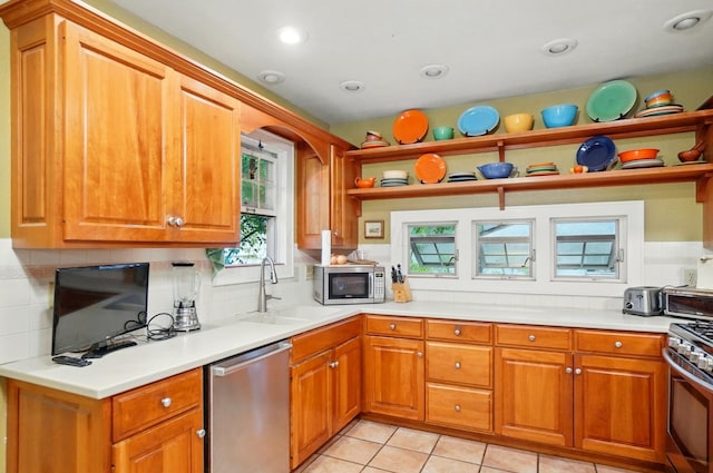 1875 King Ave, Columbus, OH 43212 - kitchen featuring stainless steel appliances, a sink, open shelves, decorative backsplash, and brown cabinets