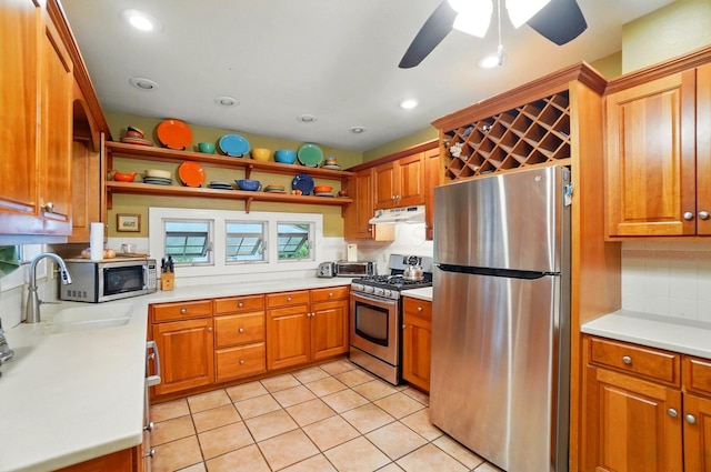 1875 King Ave, Columbus, OH 43212 - kitchen with stainless steel appliances, under cabinet range hood, light countertops, brown cabinets, and recessed lighting