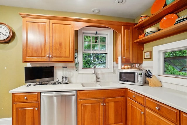 1875 King Ave, Columbus, OH 43212 - kitchen with stainless steel appliances, a sink, decorative backsplash, and light countertops