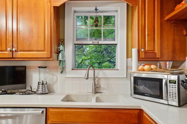 1875 King Ave, Columbus, OH 43212 - kitchen with appliances with stainless steel finishes, a sink, light countertops, and tasteful backsplash