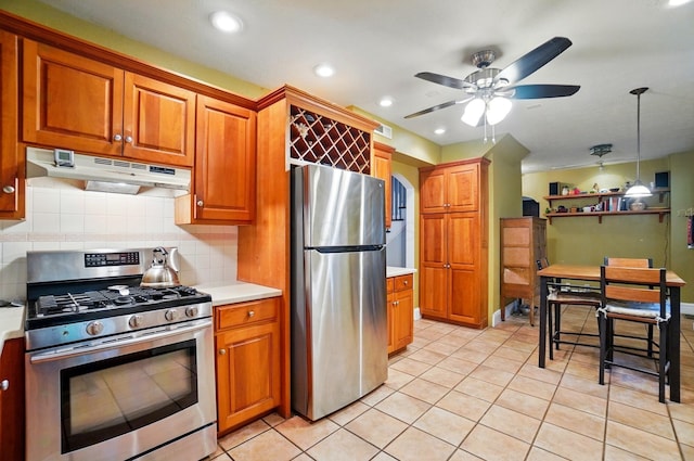 1875 King Ave, Columbus, OH 43212 - kitchen with appliances with stainless steel finishes, under cabinet range hood, brown cabinetry, light countertops, and ceiling fan