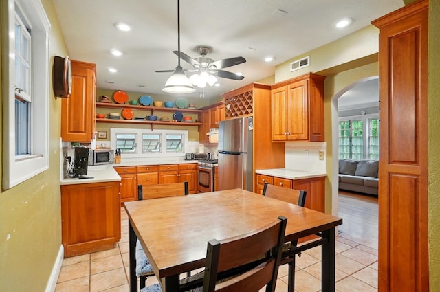 1875 King Ave, Columbus, OH 43212 - kitchen featuring stainless steel appliances, arched walkways, light countertops, a ceiling fan, and light tile patterned floors