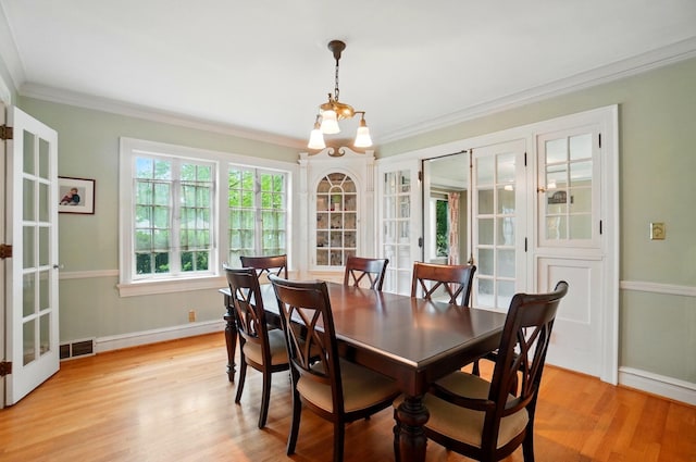 1875 King Ave, Columbus, OH 43212 - dining space featuring french doors, ornamental molding, baseboards, light wood-style floors, and a chandelier
