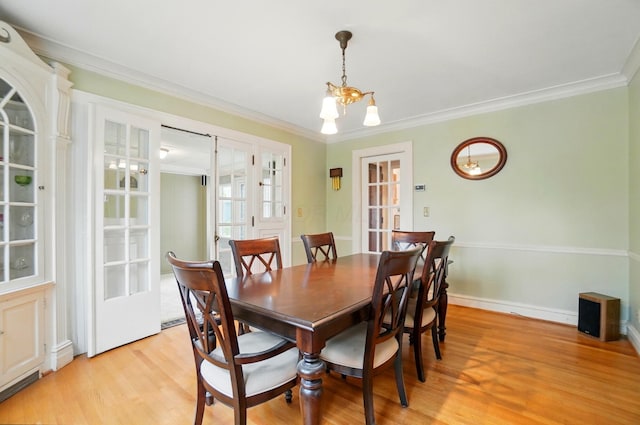 1875 King Ave, Columbus, OH 43212 - dining area featuring light wood-type flooring, crown molding, and a chandelier
