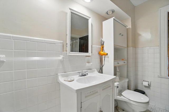 1875 King Ave, Columbus, OH 43212 - bathroom with tile walls, vanity, toilet, and a wainscoted wall