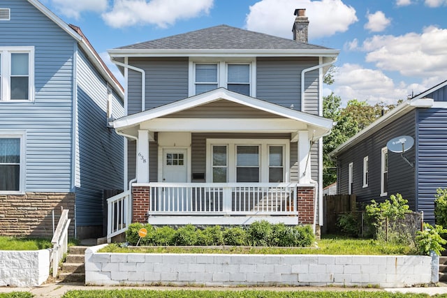 638 Stewart Ave, Columbus, OH 43206 - traditional style home featuring a chimney, a porch, brick siding, and a shingled roof