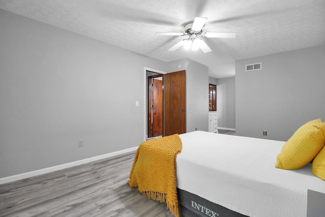 232 Camrose Ct, Columbus, OH 43230 - bedroom featuring a textured ceiling, wood finished floors, baseboards, and ceiling fan