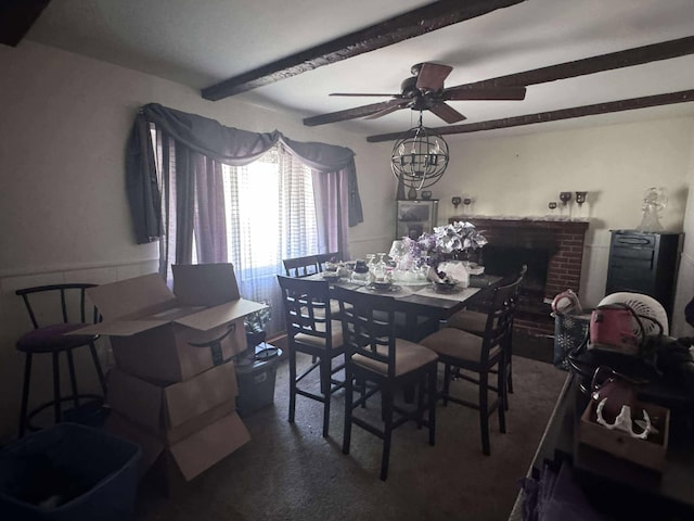 1385 Gumwood Dr, Columbus, OH 43229 - carpeted dining area with beamed ceiling, a ceiling fan, and a fireplace