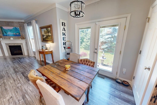 2096 English Turn Dr, Grove City, OH 43123 - dining room featuring a chandelier, wood finished floors, baseboards, crown molding, and a fireplace