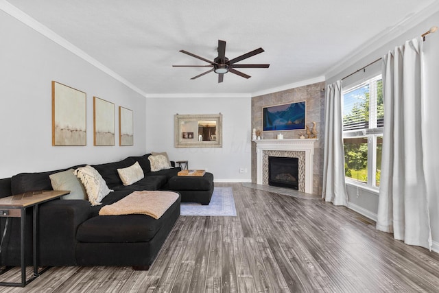 2096 English Turn Dr, Grove City, OH 43123 - living room featuring crown molding, wood finished floors, ceiling fan, a fireplace, and baseboards