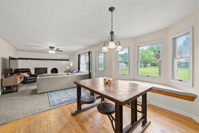 13682 Cobblestone Ln, Pickerington, OH 43147 - dining area featuring light wood-type flooring, healthy amount of natural light, a textured ceiling, and ceiling fan