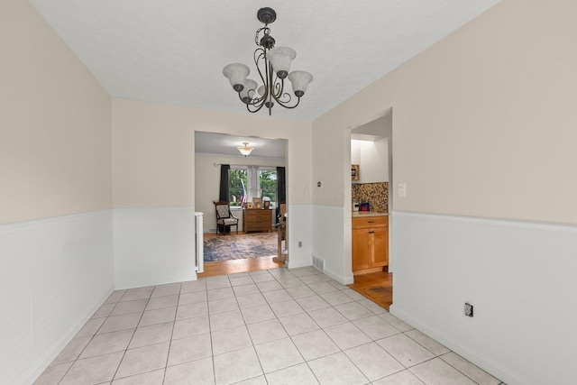 13682 Cobblestone Ln, Pickerington, OH 43147 - unfurnished dining area with a chandelier and light tile patterned floors