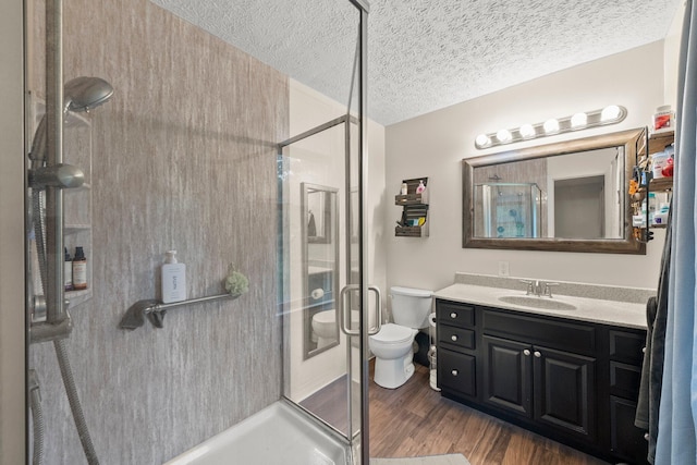 13682 Cobblestone Ln, Pickerington, OH 43147 - full bath with toilet, a shower stall, wood finished floors, vanity, and a textured ceiling
