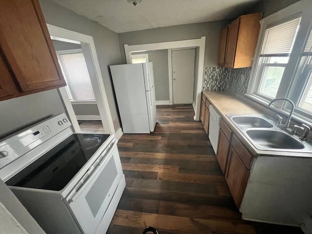 1403 Genessee Ave, Columbus, OH 43211 - kitchen with white appliances, a sink, dark wood-type flooring, decorative backsplash, and brown cabinetry
