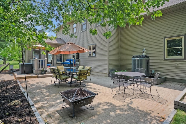 3902 Maple Grove Rd, Marion, OH 43302 - view of patio / terrace featuring outdoor dining area, a fire pit, and cooling unit