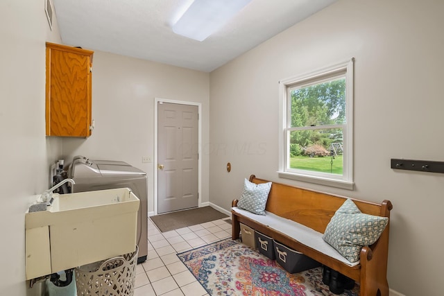 3902 Maple Grove Rd, Marion, OH 43302 - laundry area featuring washer and clothes dryer, light tile patterned floors, cabinet space, and baseboards