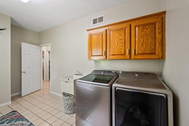 3902 Maple Grove Rd, Marion, OH 43302 - laundry area with cabinet space, washer and clothes dryer, baseboards, and light tile patterned floors