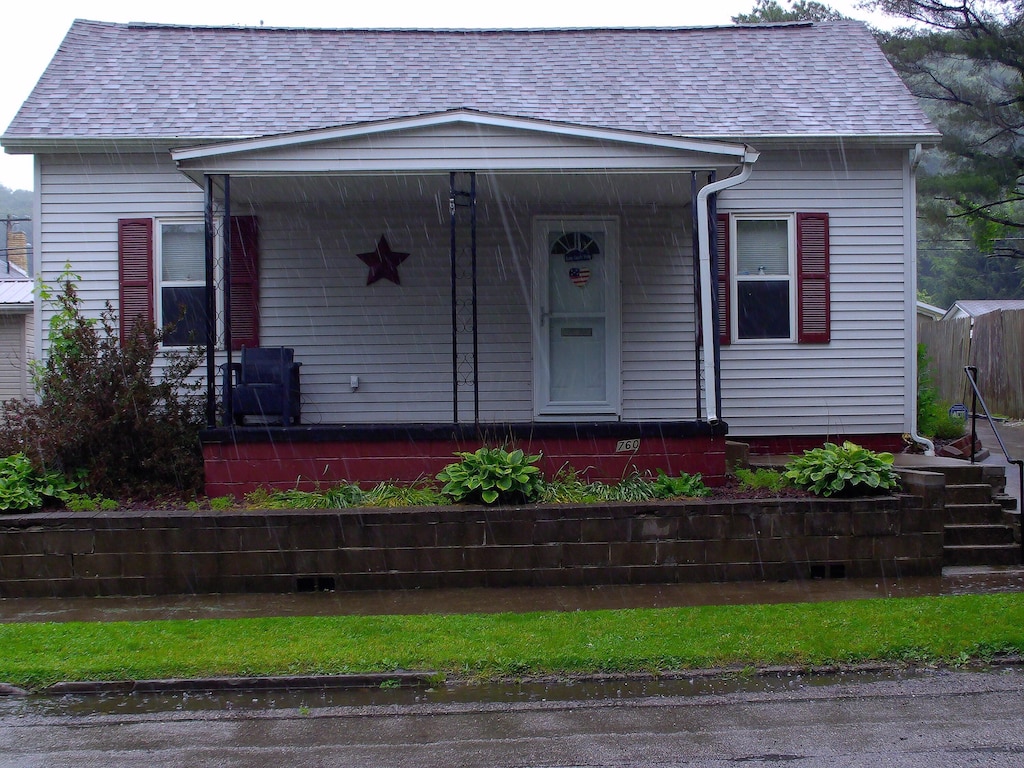 760 Poplar St, Nelsonville, OH 45764 - view of front of property with covered porch and roof with shingles