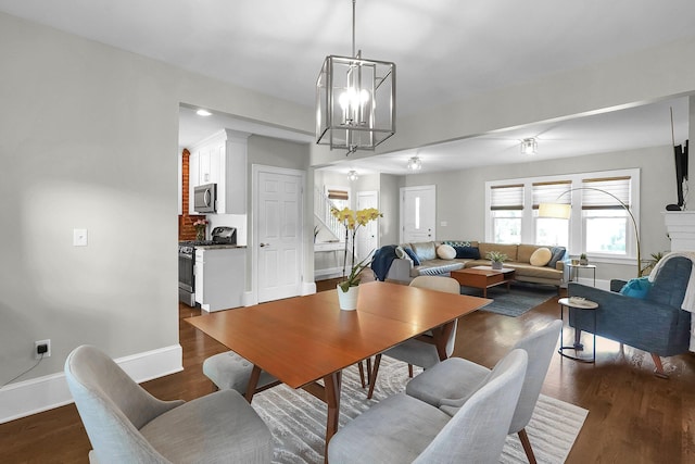 1450 Haines Ave, Columbus, OH 43212 - dining room featuring a chandelier, baseboards, and dark wood-style flooring