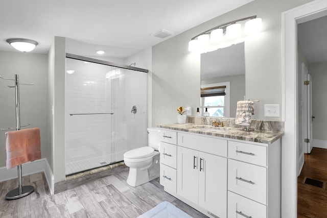 1450 Haines Ave, Columbus, OH 43212 - full bathroom with vanity, a shower stall, toilet, baseboards, and wood finished floors