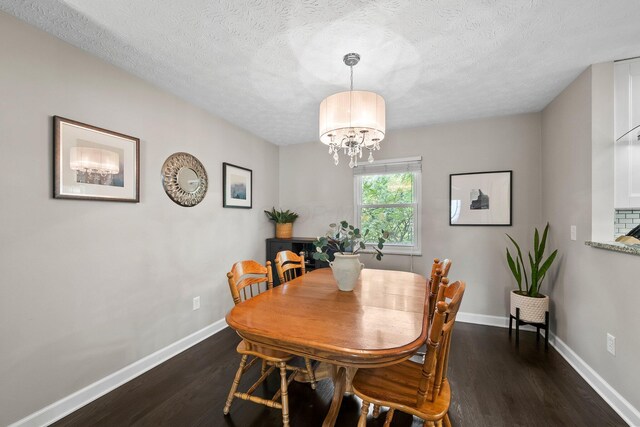 3567 Rochfort Bridge Dr, Columbus, OH 43221 - dining space featuring dark wood-type flooring, a chandelier, baseboards, and a textured ceiling