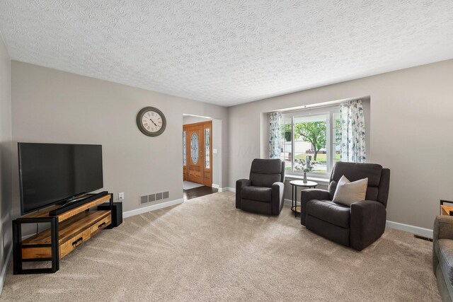 3567 Rochfort Bridge Dr, Columbus, OH 43221 - living room with carpet floors, a textured ceiling, and baseboards