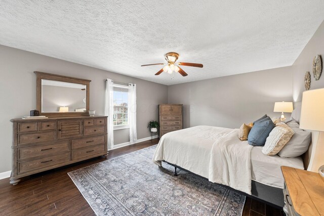 3567 Rochfort Bridge Dr, Columbus, OH 43221 - bedroom with dark wood-style floors, baseboards, ceiling fan, and a textured ceiling