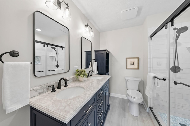 3567 Rochfort Bridge Dr, Columbus, OH 43221 - full bath featuring double vanity, a shower stall, baseboards, and toilet