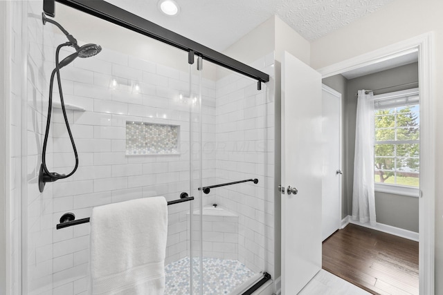 3567 Rochfort Bridge Dr, Columbus, OH 43221 - bathroom featuring a stall shower, baseboards, and wood finished floors