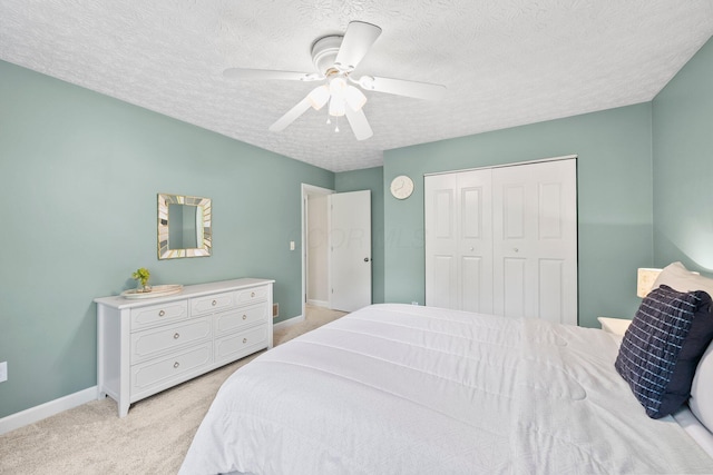 3567 Rochfort Bridge Dr, Columbus, OH 43221 - bedroom featuring light carpet, baseboards, a textured ceiling, a closet, and a ceiling fan