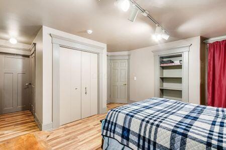 7050 Motts Place Rd, Canal Winchester, OH 43110 - bedroom with rail lighting, light wood finished floors, and a ceiling fan