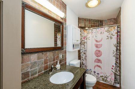 7050 Motts Place Rd, Canal Winchester, OH 43110 - bathroom featuring toilet, vanity, and tasteful backsplash