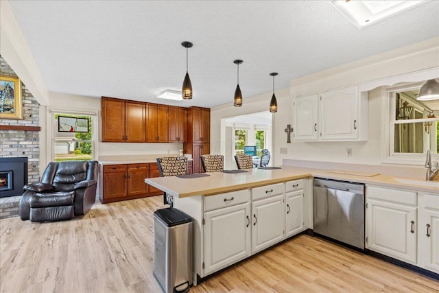 1205 Holton Rd, Grove City, OH 43123 - kitchen with dishwasher, light wood finished floors, light countertops, a peninsula, and white cabinets