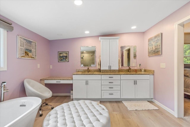 1205 Holton Rd, Grove City, OH 43123 - full bath featuring wood finished floors, a soaking tub, double vanity, recessed lighting, and baseboards