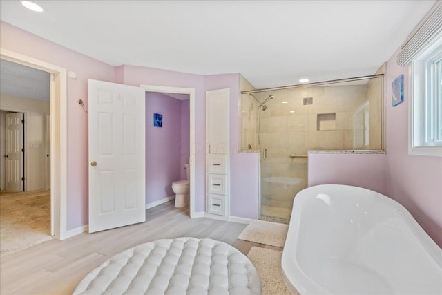 1205 Holton Rd, Grove City, OH 43123 - bathroom with a shower stall, a soaking tub, wood finished floors, toilet, and recessed lighting