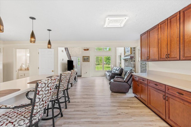 1205 Holton Rd, Grove City, OH 43123 - kitchen with light wood-style floors, open floor plan, light countertops, and a kitchen bar